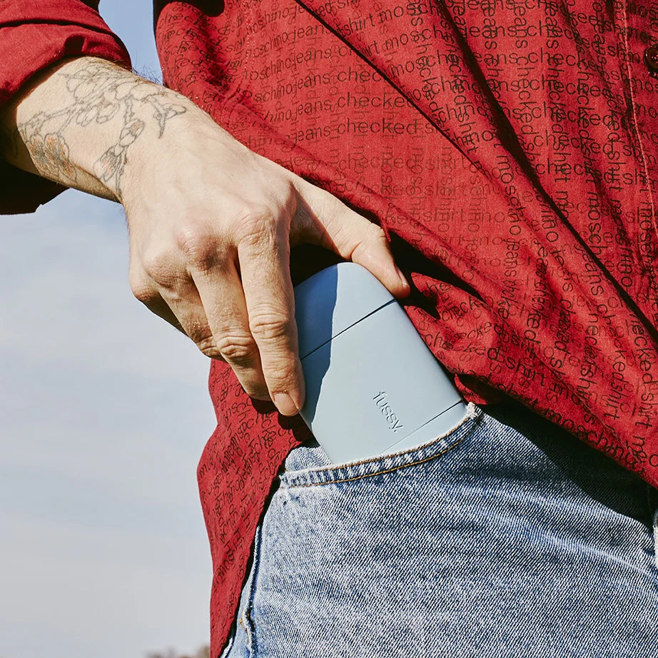 A Fussy refillable deodorant slipped into a jeans pocket